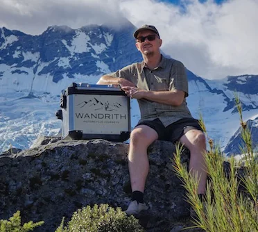 Patrick with a pannier up a mountain