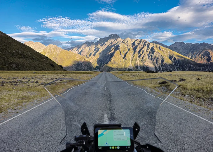 Rider filming with a GoPro on a coastal New Zealand road