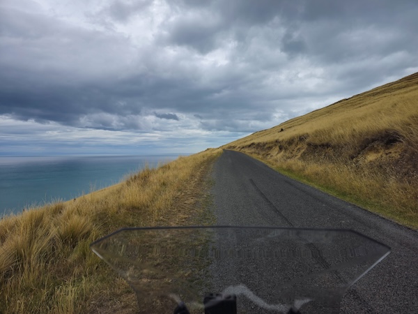 Motorcycle on country road with a view of the sea
